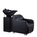 Side profile of the Karma Mortlake salon basin unit showing the black ergonomic chair and integrated shampoo sink