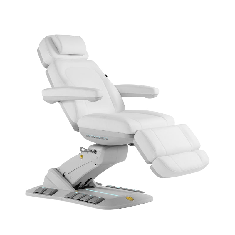 Fully adjustable electric beauty treatment chair in white with tilted backrest and leg rest