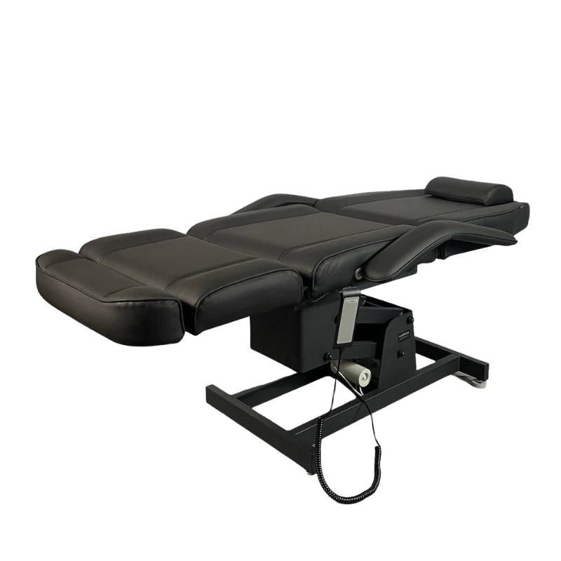 Black electric beauty bed in fully flat position suitable for massage and body treatments