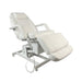 White Karma Rotorua electric treatment table tilted for client comfort in a professional clinic