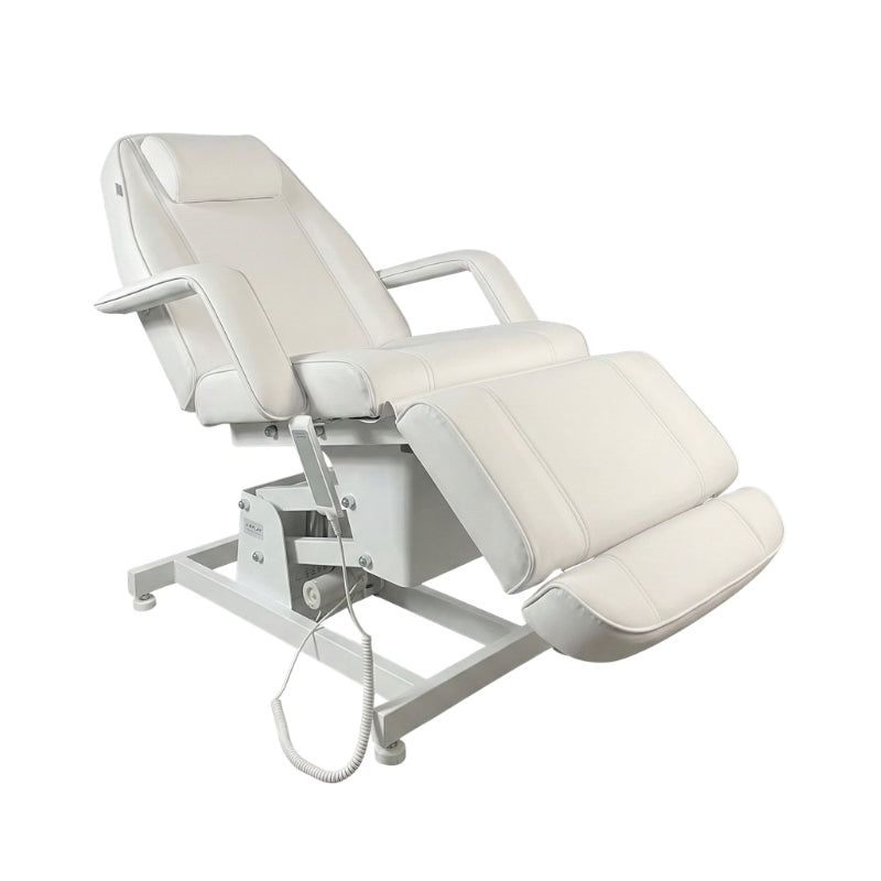 White Karma Rotorua electric treatment table tilted for client comfort in a professional clinic