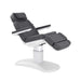 Karma Stratford electric treatment table featuring charcoal grey upholstery and white column base