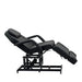 Karma Taupo hydraulic beauty bed in black demonstrating the Trendelenburg tilt position for clinical use