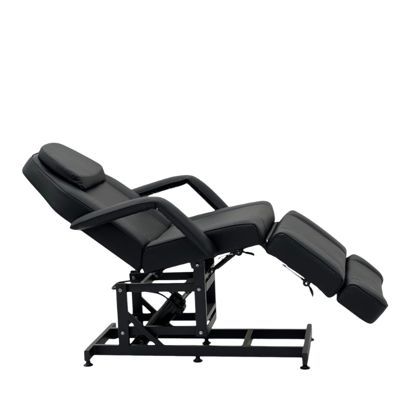 Karma Taupo hydraulic beauty bed in black demonstrating the Trendelenburg tilt position for clinical use