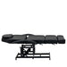 Karma Taupo black hydraulic beauty bed shown in a fully flat horizontal position for massage treatments