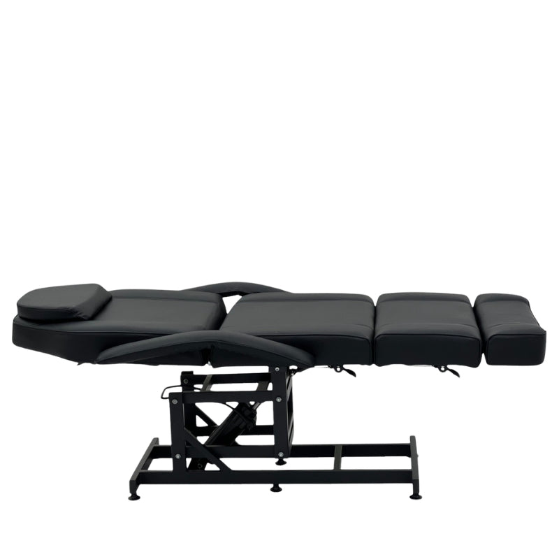 Karma Taupo black hydraulic beauty bed shown in a fully flat horizontal position for massage treatments