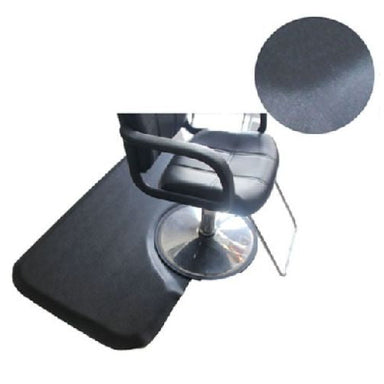 Karma thick rectangular black anti fatigue hairdressing mat placed under a professional salon styling chair