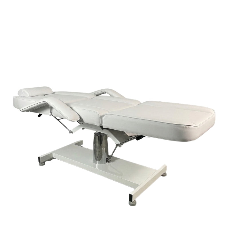 White Karma Wellington beauty bed adjusted to a flat horizontal position for massage treatments