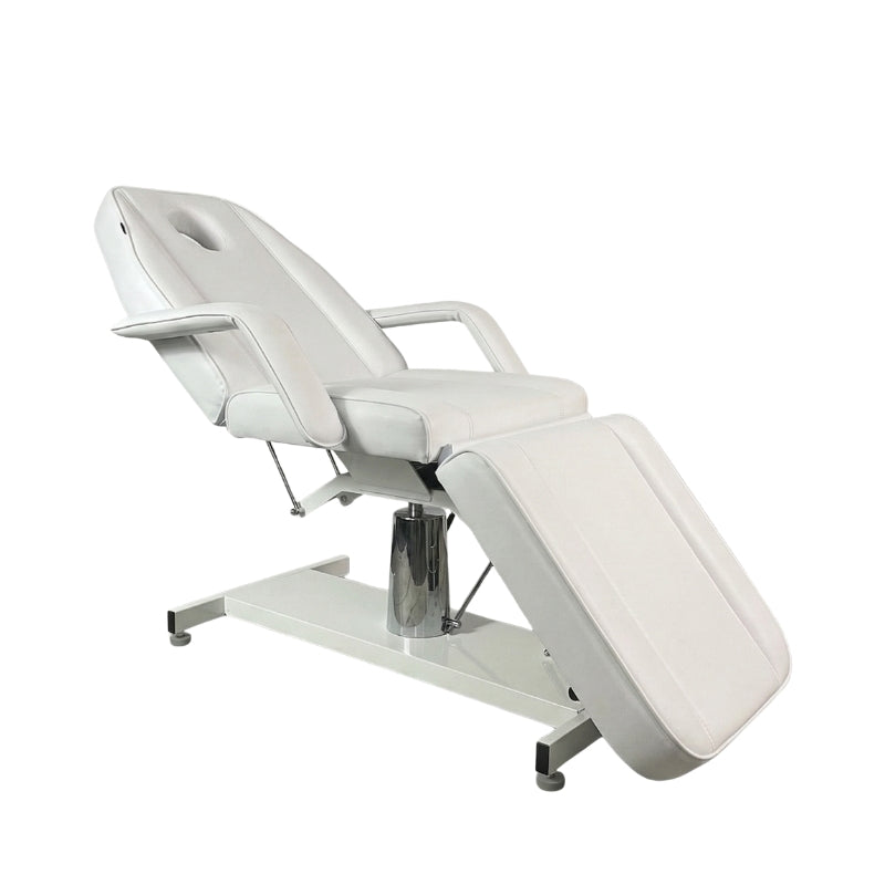Side profile of the white Karma Wellington hydraulic bed showing the heavy duty base and pump