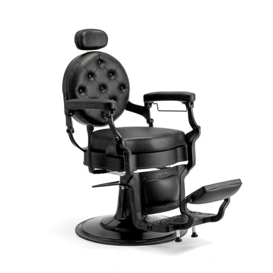 Black upholstered barber chair with adjustable footrest and armrests