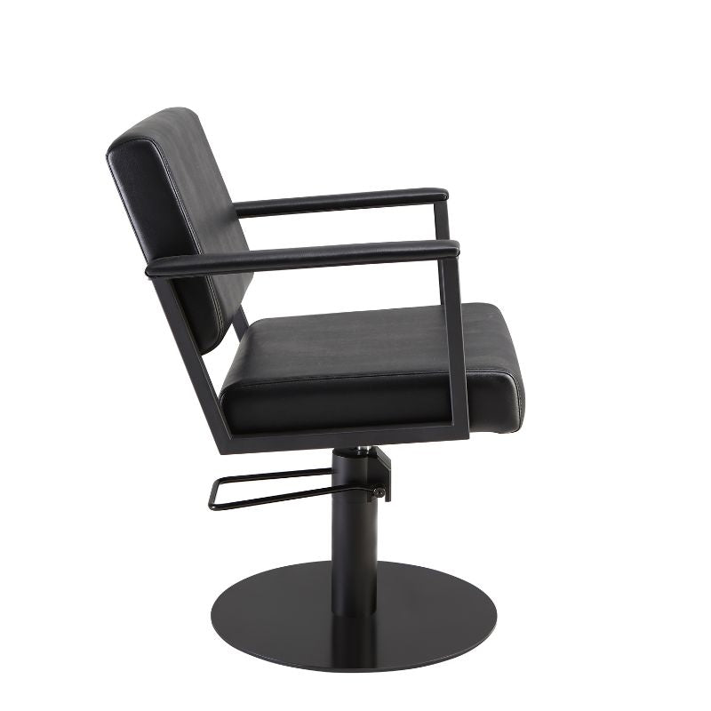 Side view of black salon styling chair showing armrests and seat profile