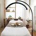 A high-resolution lifestyle shot featuring a sleek, white LED magnifying lamp positioned over a professional beauty bed in a modern Australian clinic setting