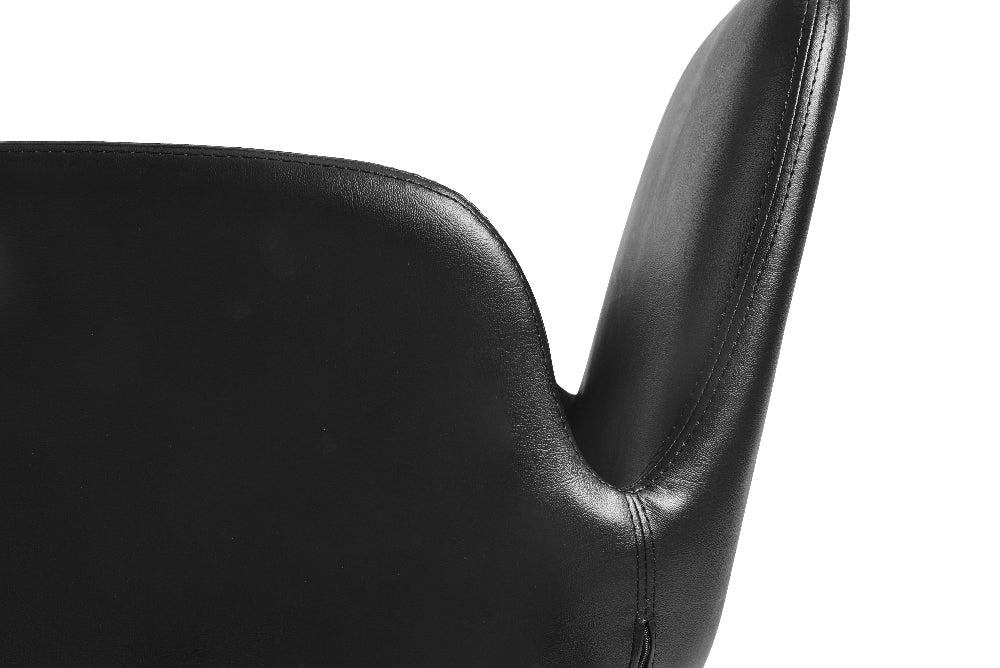 Close-up of black vinyl upholstery on salon styling chair